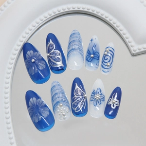 Deep blue and ice blue 3D floral press-on nails with butterfly and pearl accents