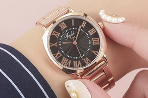 Detailed close-up of rose gold Roman numeral watch dial with elegant sunray black face