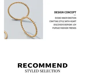 Detail of 18k gold plated stainless steel bead rings showing minimalist polished finish