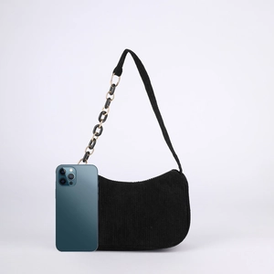 Black corduroy shoulder bag with chain strap and phone for size comparison