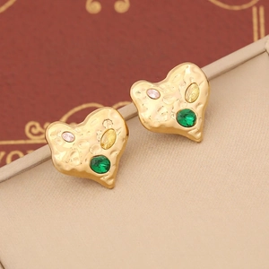 Detail of heart-shaped gold studs with hammered texture and colorful stones