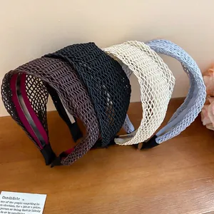 Woven wide-brimmed headbands in brown, black, cream, and light blue with non-slip combs