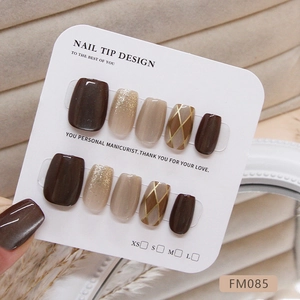 Cat eye checkerboard press-on nail set in deep brown and beige with gold glitter