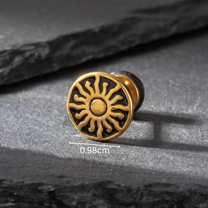 Detail of a 0.98cm gold stainless steel earring with black sun pattern on stone background
