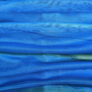 Close-up of blue mesh fabric texture showing detailed weave and natural soft folds