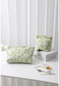 Detailed set of green floral quilted makeup bags with golden flower zipper and elegant design