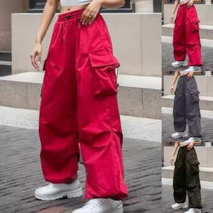 Detail view of multi-color baggy cargo pants featuring large utility pockets and adjustable drawstrings