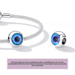 Macro shot of S925 sterling silver evil eye charm featuring blue and purple enamel details