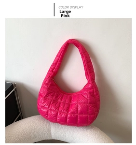 Detail of large pink quilted puffy shoulder bag in glossy nylon with zipper closure
