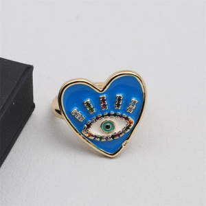 Detail showing gold heart-shaped ring with blue enamel evil eye and colored zircons