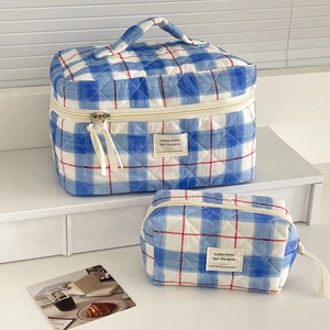 Quilted blue checkered cosmetic bag set with carry handle and small toiletry pouch