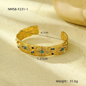 Detail view of hammered gold cuff with turquoise and crystals measuring 6.1cm diameter