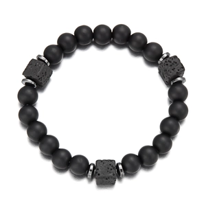 Detail of matte black beads and cubic volcanic stones on a minimalist beaded bracelet