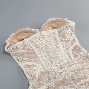 Detailed close-up of ivory lace bodice with inner cups and elastic back zipper closure