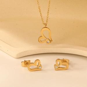 Golden heart jewelry set with necklace and earrings featuring white cubic zirconia stones