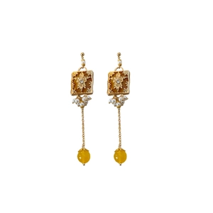 Vintage style gold earrings with amber floral center and hanging pearl tassels