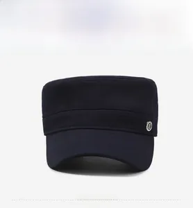 Detail of military flat top cap with metal buckle emblem and reinforced stitching