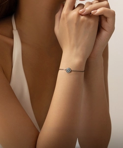 Détail du bracelet en argent S925 noir avec pendentif turquoise rond porté au poignet