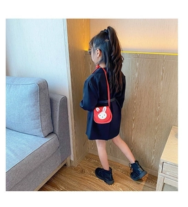 Toddler girl wearing a cute red bunny crossbody bag shown from a back view profile