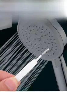 Close-up of small cleaning brush for unclogging shower head nozzles and gaps