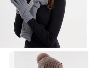 Detail of gray knitted scarf and gloves set with a brown bobble hat for winter warmth
