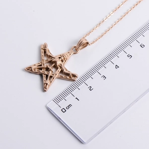 Rose gold punk star skull pendant necklace shown with a ruler for 3.5cm size reference
