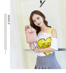 Asian model showcasing a pink mini cross-body mobile phone bag for women in 2024
