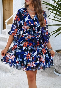 Detailed view of floral print chiffon dress featuring ruffled cuffs and a waist tie