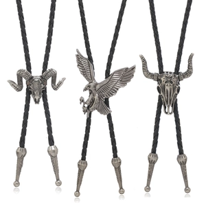 Three vintage Bolo ties with silver eagle, ram, and bull skull pendants on black cords