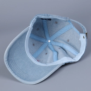 Detailed interior of denim baseball cap showing premium seams and branded inner label