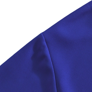 Close-up of royal blue breathable mesh knit fabric texture on men's polo t-shirt