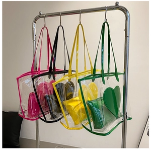 Detailed display of four transparent PVC tote bags with colorful heart-shaped inner pouches