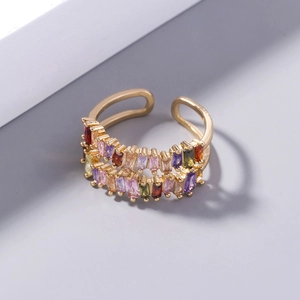Detail of gold double-row open ring featuring multi-color rectangular zircon stones