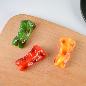 Realistic artificial grilled bell pepper models in red, green, and yellow for decor