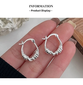 Close-up of S925 sterling silver hoop earrings with vintage twisted rope texture design