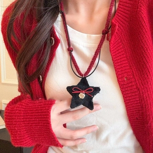 Knitted star pendant necklace with red bow and plush star on black leather cord