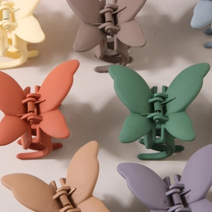 Matte butterfly hair claw clips set in various muted colors and frosted ABS material