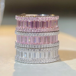 Macro shot of stacked S925 sterling silver eternity bands with pink and white diamonds