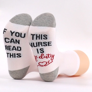 Detail of funny nurse socks with text If You Can Read This This Nurse Is Off Duty