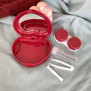 Deep red heart-shaped contact lens case set with mirror, tweezers and solution bottle