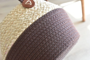 Handwoven straw and cotton rope storage basket with leather handle for home organization