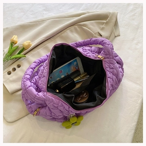 Detail view of purple quilted bubble tote bag showing large capacity for phone and cosmetics