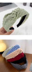 Detail of multi-color twisted knot headbands with woven texture and fabric finish