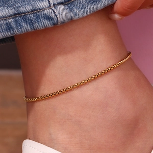Close-up of 18K gold plated stainless steel box chain anklet on female model ankle