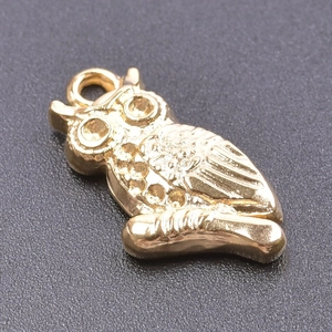 Detailed golden owl charm pendant with textured feathers in stainless steel metal