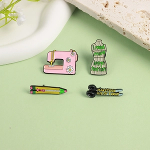 Set of four sewing themed enamel pins with pink machine and scissors on green backdrop