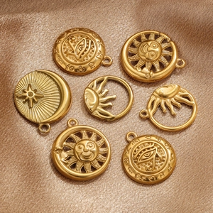 Macro detail of 18K gold plated sun and moon charms for DIY jewelry making