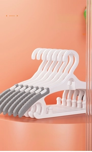 Detail of retractable plastic kids clothes hangers with non-slip gray padded shoulders