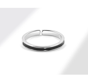 Close-up of silver open ring with black enamel stripe and polished metallic finish
