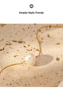 Close-up of minimalist gold stainless steel necklace with a single white pearl pendant